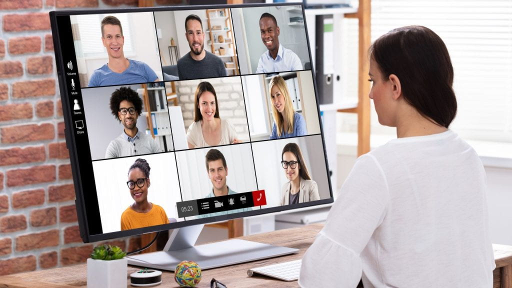 A person is having a remote meeting over a videoconferencing tool with several other people