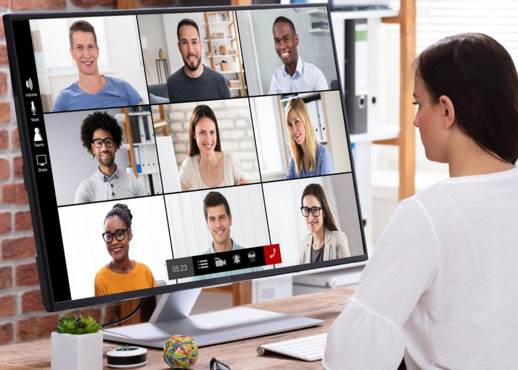 A person is having a remote meeting over a videoconferencing tool with several other people