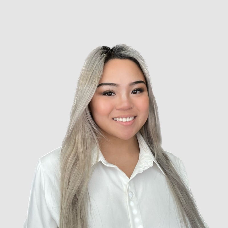 Headshot of Amanda Ong smiling at the camera. She is a female with long blonde hair and wearing a white blouse.